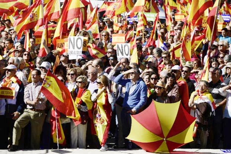 People hold signs reading "No to the coup"" during a demonstration in Madrid to call for Spanish unity after the Catalan parliament declared independence"
