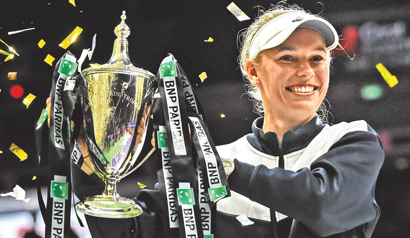 Caroline Wozniacki of Denmark lifts the trophy after winning against Venus Williams of the US during the WTA Finals single tennis tournament in Singapore on Sunday.