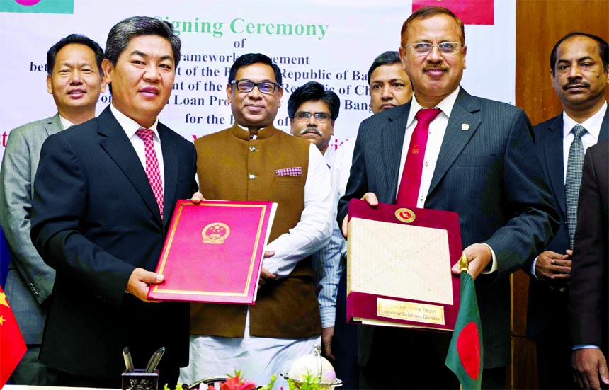 Ma Mingqiang, Chinese ambassador to Dhaka and Kazi Shafiqul Azam, Secretary of Economic Relations Division, exchanging a signing document of a concessional loan for single point mooring (SPM) with double pipe line at secretariat in Dhaka on Sunday. State