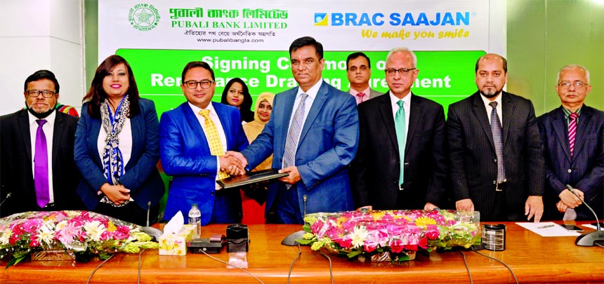 Md. Abdul Halim Chowdhury, Managing Director of Pubali Bank Limited and Abdus Salam, Managing Director of UK baesd BRAC Saajan Exchange Limited, exchanging an agreement signing documents at the bank's head office in the city on Monday. Under the deal, Ba