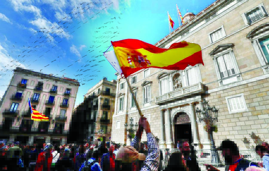 Spanish and Catalan separatist flags are waved in front of the Generalitat Palace, the Catalan regional government headquarters in Barcelona, Spain on Monday.