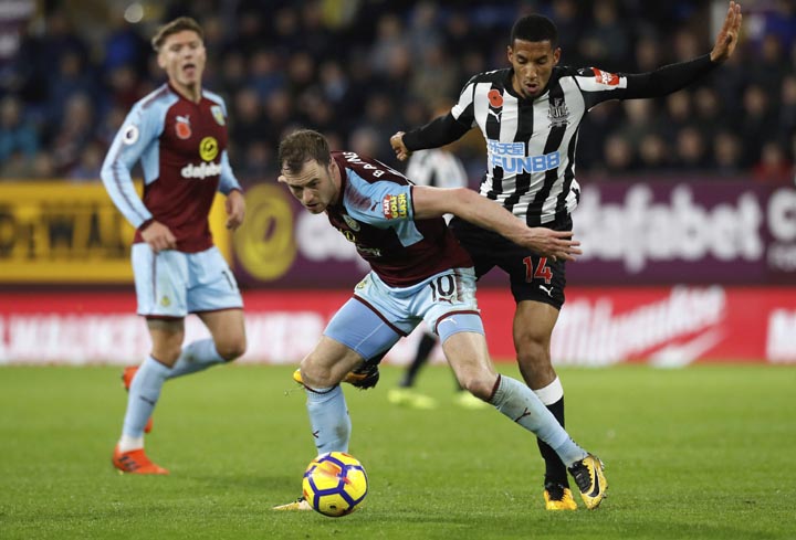 Burnley's Ashley Barnes (left) and Newcastle United's Isaac Hayden battle for the ball during the English Premier League soccer match Burnley versus Newcastle at Turf Moor in Burnley, England on Monday.