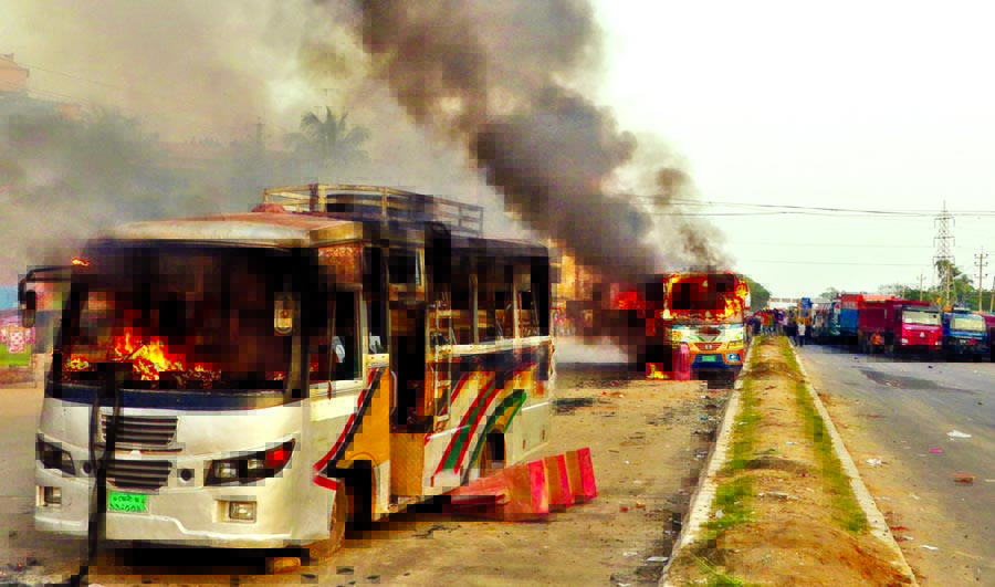 Unidentified miscreants torched two buses on Dhaka-Chittagong highway while the convoy of BNP Chairperson Begum Khaleda Zia passing through Mahipal area in Feni on Tuesday.