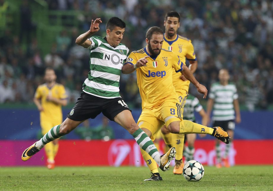 Juventus' Gonzalo Higuain (right) challenges for the ball with Sporting's Rodrigo Battaglia during a Champions League, Group D, soccer match between Sporting CP and Juventus at the Alvalade stadium in Lisbon on Tuesday.