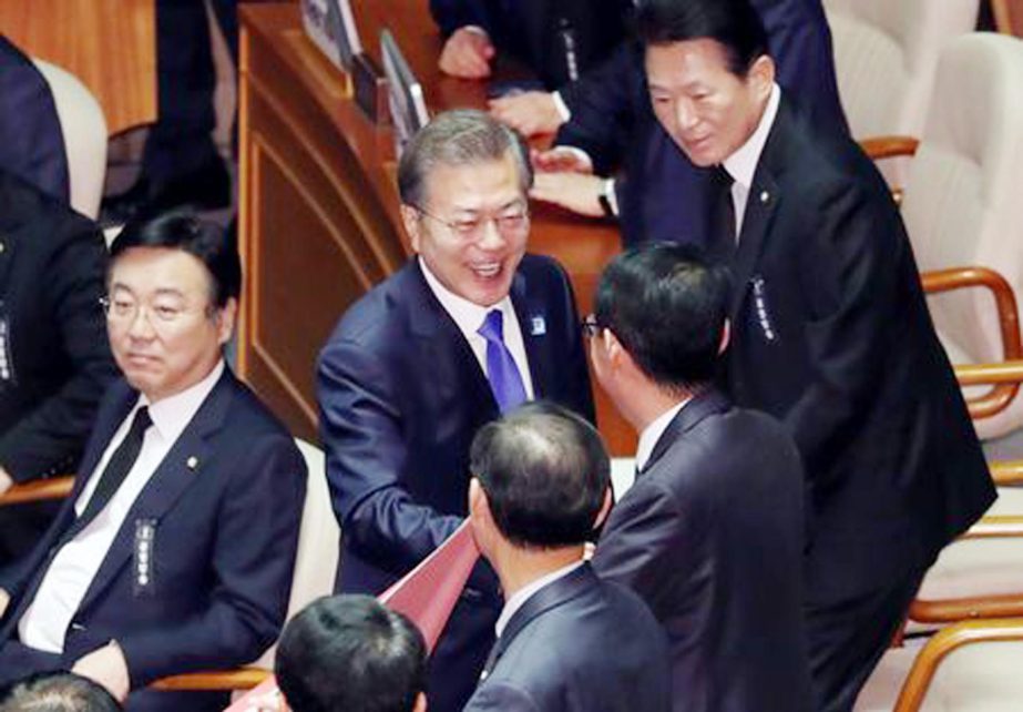 South Korean President Moon Jae-in smiles after delivering his speech on the 2018 budget bill during a plenary session at the National Assembly in Seoul on Wednesday.