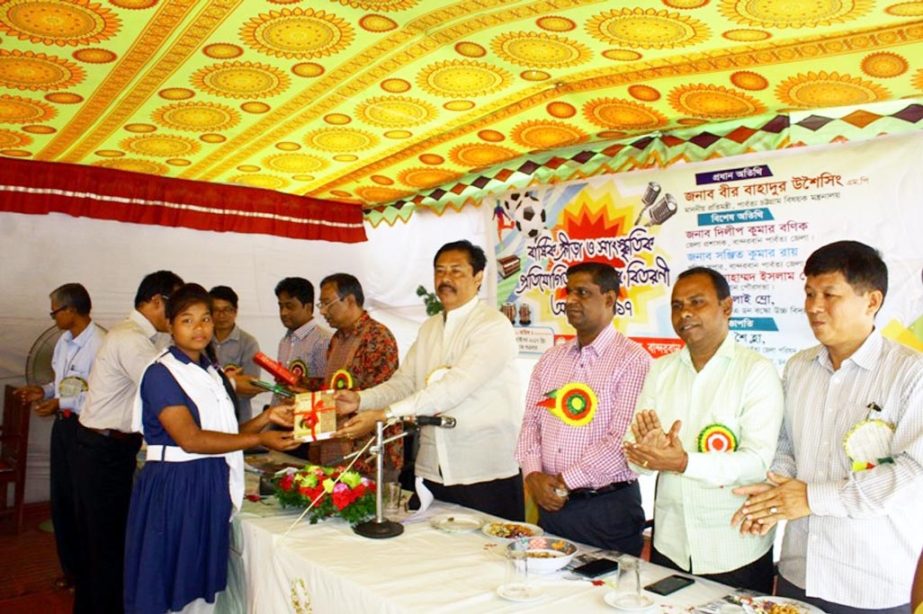 State Minister for Chittagong Hill Tract Affairs Bir Bahadur Ushwi Sing MP distributing prizes among the winners of annual sports and cultural competition of Donbusko HIgh School in Bandarban Sadar Upazila on Friday.