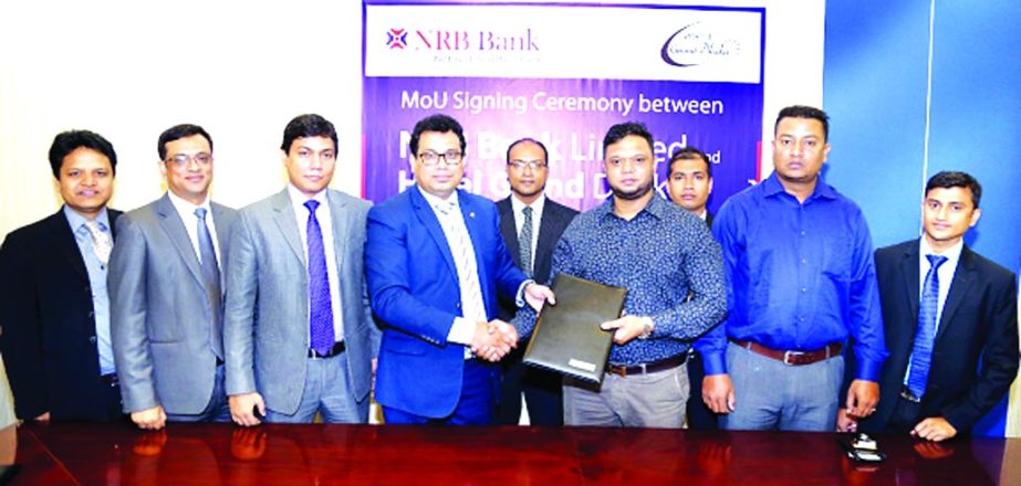 Imran Ahmed FCA, Chief Operating Officer of NRB Bank Limited and Sabbir Ahmed Bokshi, Managing Director of Grand Dhaka Hotel Limited, exchanging an agreement signing documents at the bank's head office in the city on Tuesday. Under the deal, Debit and Cr