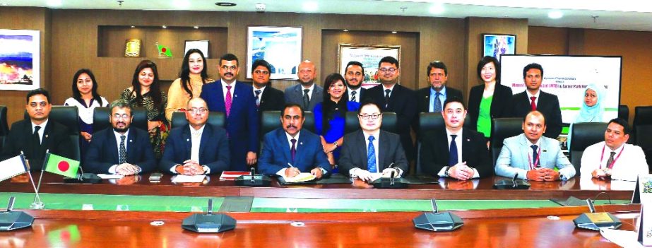 Syed Rafiqul Haq, Chief Business Officer of Mutual Trust Bank Limited and Lewis Ng, Head of Marketing of Farrer Park Hospital Singapore, exchanging a MoU signing documents at the banks head office in the city on Monday. Under the deal, employees and famil