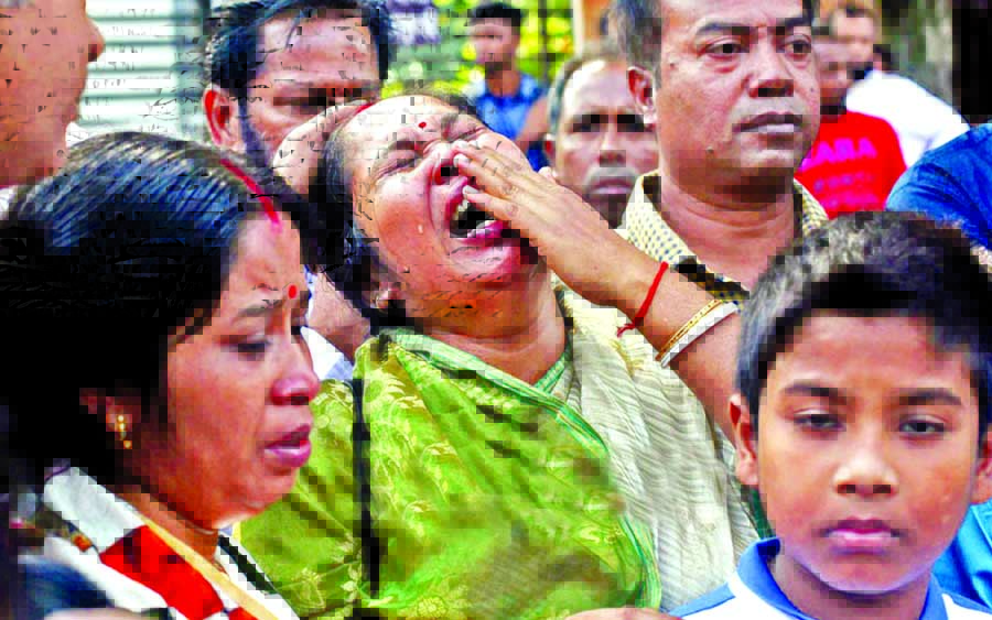 Relatives of recently disappeared Journo Utpal Das wailing at the protest rally of BFUJ, DUJ in front of Jatiya Press Club on Wednesday.