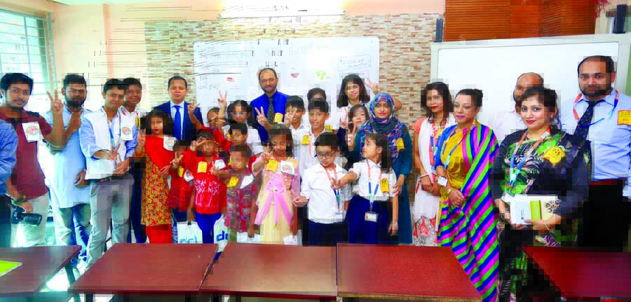 Students of Daffodil International School (DIS) along with governing body Chairman of DIS Sabur Khan pose for photograph in observance of 'Service Day-2017'on its Dhanmondi campus in the city on Thursday.