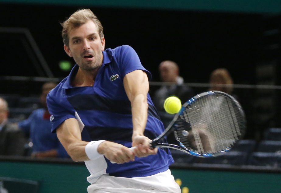 Julien Benneteau of France returns the ball to Marin Cilic of Croatia during their quarterfinal match of the Paris Masters tennis tournament at the Bercy Arena in Paris, France on Friday.