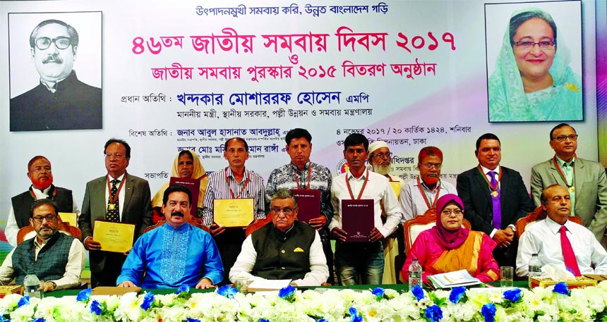 LGRD minister Khandaker Mosharraf Hossain, poses with the awardees on the occasion of 46th National Cooperative Day 2017 at a city auditorium on Saturday. Acting Secretary Mafruha Sultana of Rural Development and Cooperatives Division presided over the fu