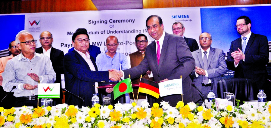 The deal documents being handed over to each other after signing MoU between North-West Power Generation Company Limited, Bangladesh and Siemens A.G, Germany, at Bidyut Bhaban on Sunday, to build 3600MW LNG run power plant at Payra in Patuakhali. PM's En