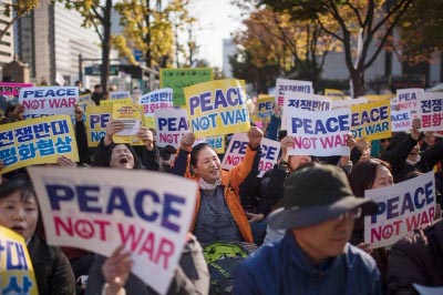 Demonstrators hold placards during a peace rally in Seoul on Sunday.