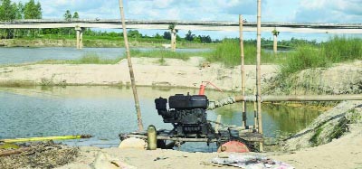 RANGPUR: Illegal sand lifting is going on unabated from Jomuneshwari River at Chharan area of Mithapukur Upazila posing threat to Jomuneshwari Bridge . This snap was taken yesterday.