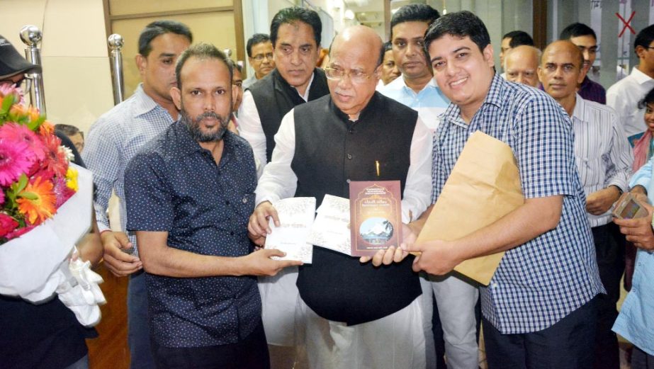 Health and Family Welfare Minister Mohammed Nasim MP receiving a Book on sufisium series-01 from Dr. Barun Acharjo Bolai at the Auditorium of Chittagong Circuit House on Sunday.