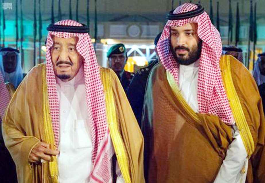 Saudi Arabia's King Salman bin Abdulaziz Al Saud walks with his son and Crown Prince Mohammed bin Salman, before King Salman leaves for Medina, in Riyadh, Saudi Arabia.