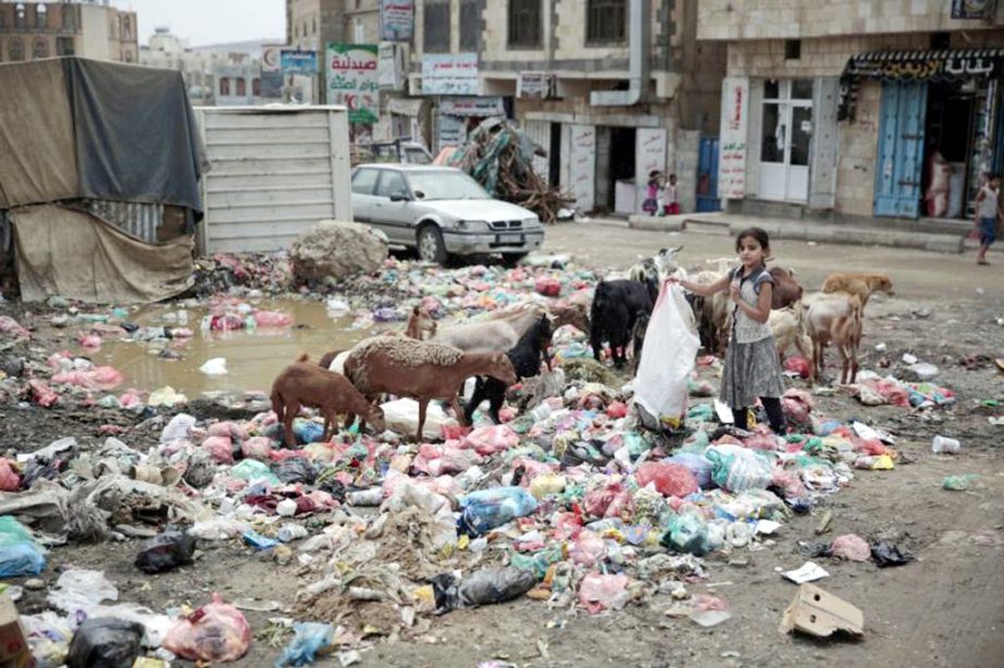 A girl scavenges at a garbage dump in a street in Sanaa, Yemen. The United Nations and more than 20 aid groups said on Thursday that the Saudi-led coalition's tightening of a blockade on war-torn Yemen could bring millions of people closer to "starvatio