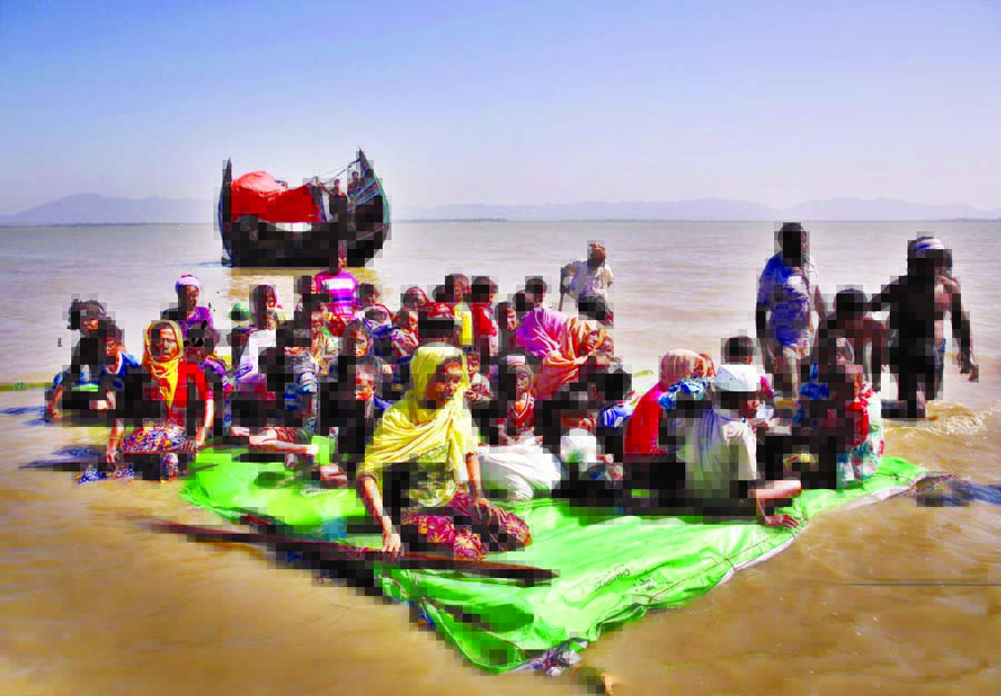 Taking life risk, the displaced Rohingyas are now using makeshift rafts made of plastic jerrycans and bamboos to cross waterways in a bid to enter Bangladesh. The above picture shows several Rohingyas, mostly women and children, reached the coastal villag