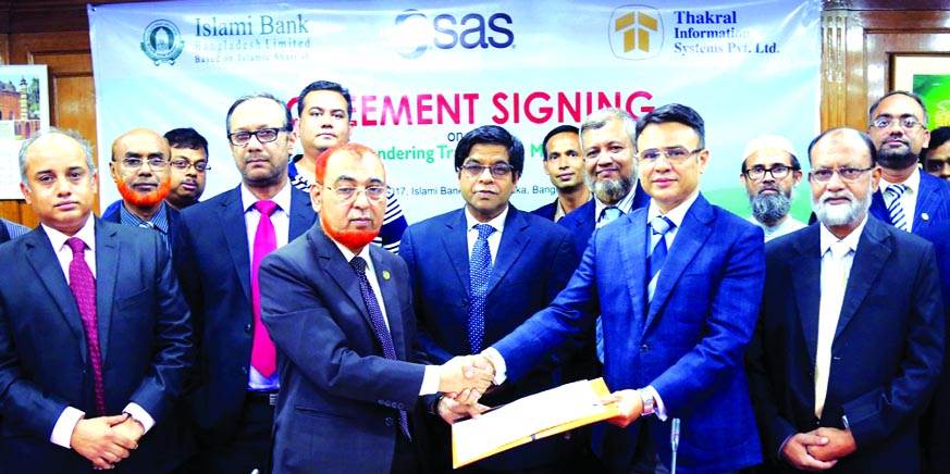 Md Shamsuzzaman, DMD of Islami Bank Bangladesh Limited and Basab Bagchi, CEO of Thakral Information Systems (Pvt.) Limited, exchanging an agreement signing documents at the bank's head office in the city on Thursday. Arastoo Khan, Chairman, Md. Mahbub-ul