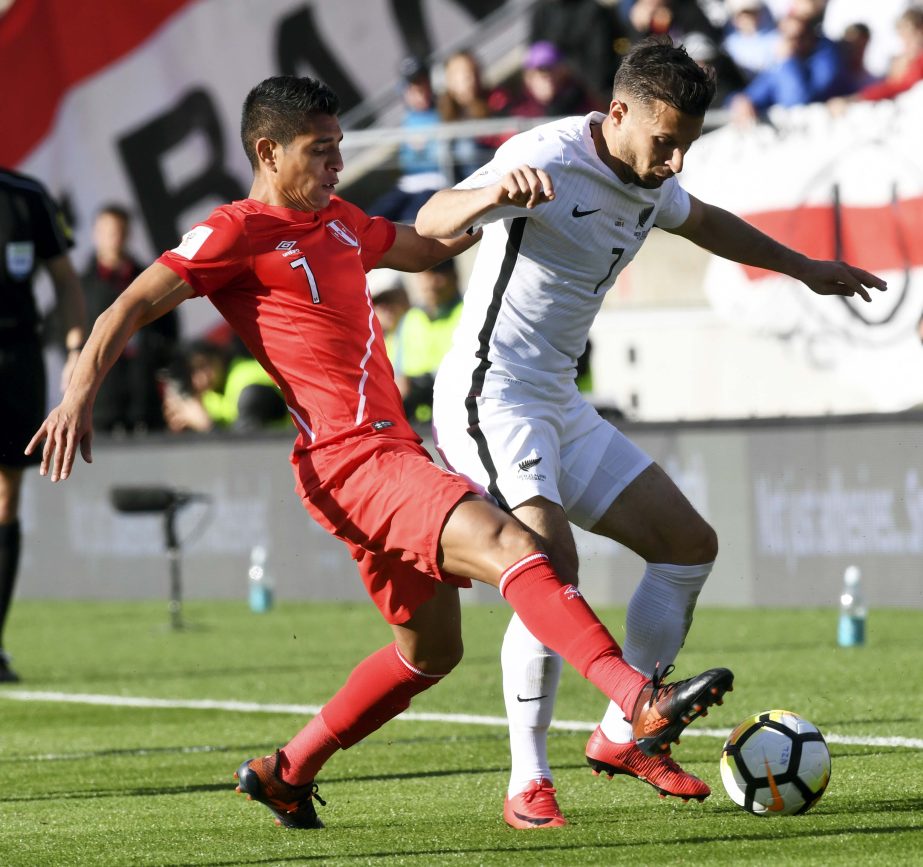 Peru's Paulo Hurtado (left) challenges New Zealand's Kosta Barbarouses for the ball during their World Cup soccer qualifying match in Wellington, New Zealand on Saturday.