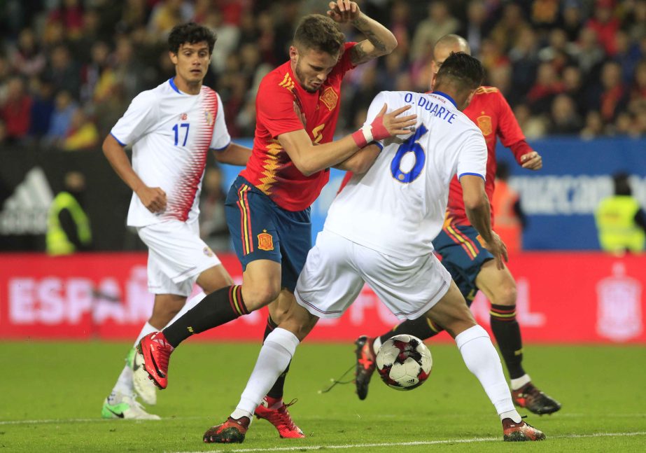 Spain's Saul Niguez (left) controls the ball past Costa Rica's Oscar Duarte during a international friendly soccer match between Spain and Costa Rica in Malaga, Spain on Saturday.