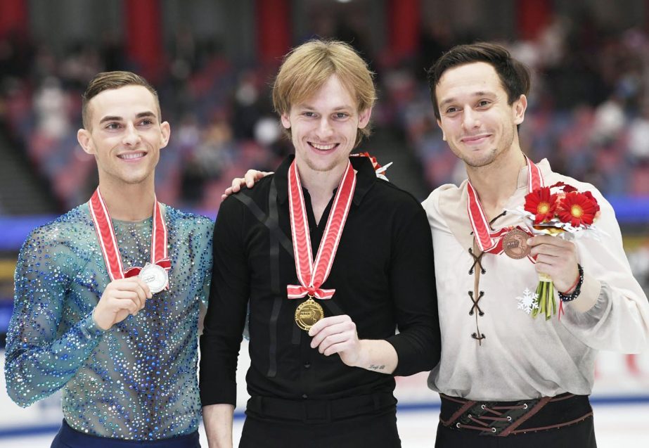 Sergei Voronov of Russia (center) poses with the gold medal, with second placed Adam Rippon of the United States (left) and third-placed Alexei Bychenko of Israel (right) at the NHK Trophy figure skating on Saturday in Osaka, western Japan.