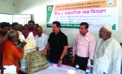GANGACHARA(Rangpur): State Minister for Rural Development and Cooperatives (LGED) Md Mashiur Rahman Ranga MP distributing seeds and fertilizer among the flood affected farmers in the Upazila on Friday.