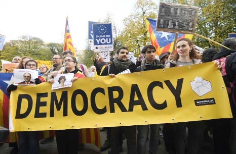 Protesters hold a banner during a demonstration by pro-Catalan independence supporters calling for the release of jailed separatist leaders.