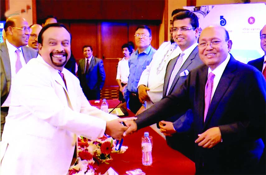 Harun-ur Rashid, Chairman of Asian Group, receiving the CIP Card from Commerce Minister Tofail Ahmed at a city hotel on Sunday. High officials of Export Promotion Bureau were present.