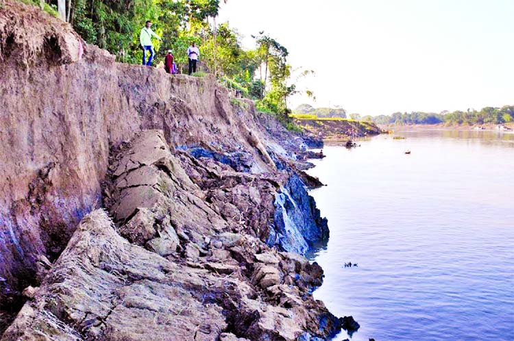 Local people passing days in panic due to the continuous breach of the bank of Surma River following navigability problem. This photo was taken from Sylhet on Monday.