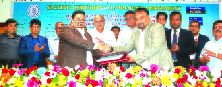 Tarique Ekramul Haque, Managing Director of Bangla Trac Group (BTG) and Dr. Ahmad Kaikaus, Secretary, Power Division of Bangladesh Power Development Board (BPDB) exchanging an agreement signing documents at Biddut Bhaban in the city recently. Under the de