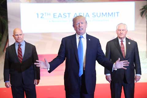 Flanked by U.S. National Security Advisor H.R. McMaster, (left) and U.S. Secretary of State Rex Tillerson, US President Donald Trump offers a departing statement after participating in an East Asia Summit on Tuesday in Manila