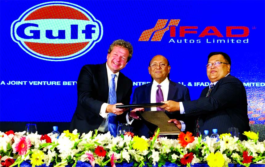 Iftekhar Ahmed Tipu, Chairman of Ifad Autos Limited and Frank Rutrren, Vice-Chairman of Gulf Oil Internation, exchanging an agreement signing document at the Autos office in the city recently. Under the deal, Ifad Autos will manufacture and marketing the