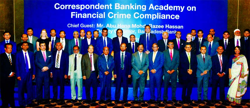 Bangladesh Bank's Deputy Governor Abu Hena Mohd. Razee Hassan,poses with the participants of a daylong workshop on "Correspondent Banking Academy on Financial Crime Compliance" at Standard Chartered Bank Bangladesh office in the city recently. Naser E