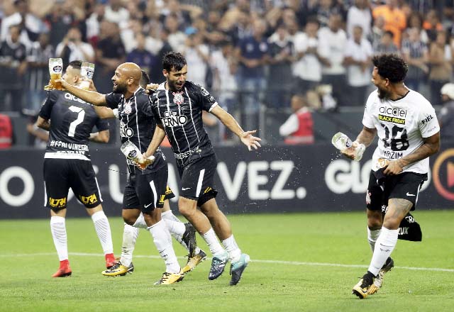 Corinthians players carry drinks as they celebrate winning the Brasileirao soccer championship title, after their match with Fluminense in Sao Paulo, Brazil on Wednesday. Corinthians won 3-1.