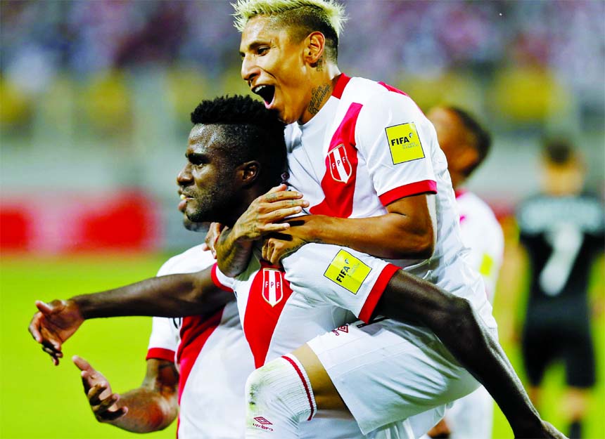 Peru's Raul Ruidiaz rides on the back of teammate Christian Ramos, after Ramos scored his team's second goal against New Zealand during a play-off qualifying match for the 2018 Russian World Cup in Lima, Peru on Wednesday.