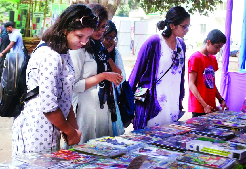 Buyers at a book stall set up on the occasion of Dhaka Lit Fest-2017 on Bangla Academy premises in the city on Saturday.