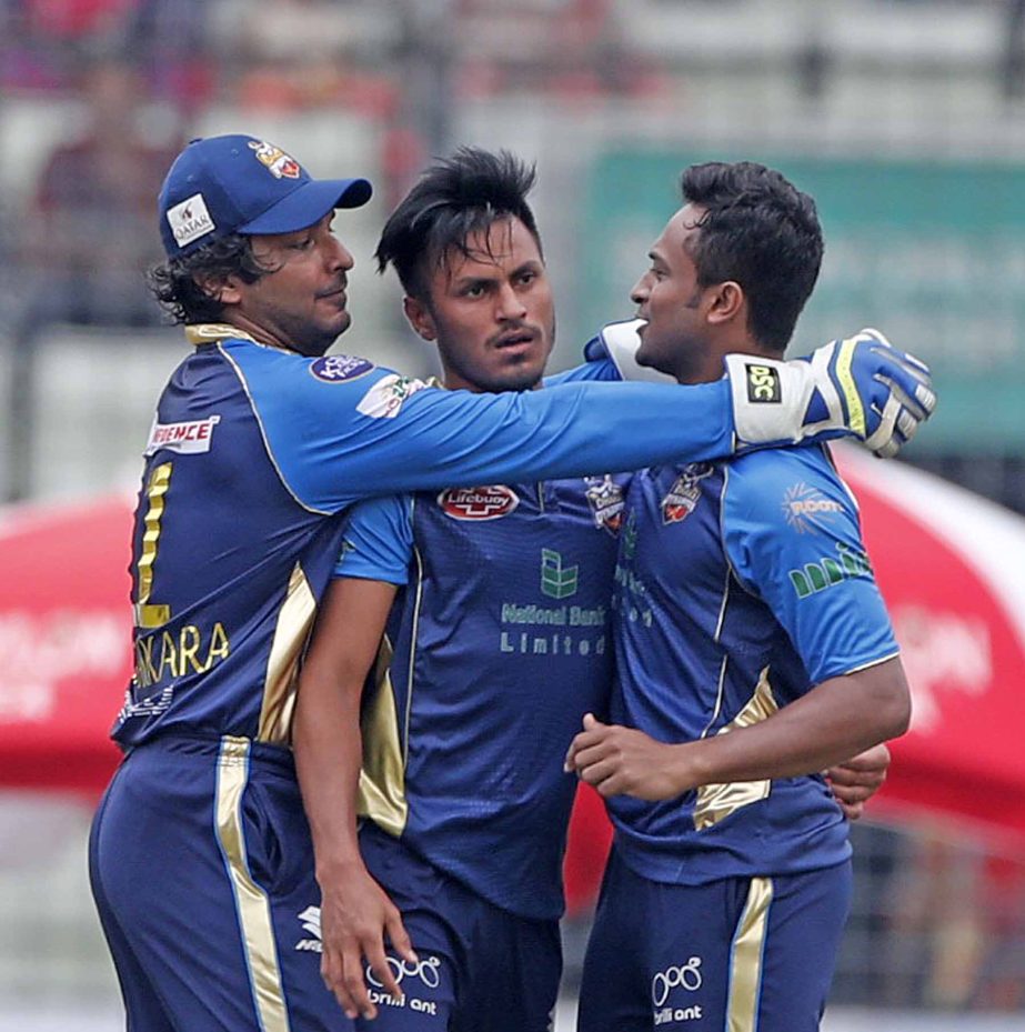 Kumar Sangakkara (left) of Dhaka Dynamites hugs his teammate Shakib Al Hasan (right) after dismissal of a wicket of Rajshahi Kings during the match of the AKS Bangladesh Premier League (BPL) Twenty20 Cricket between Dhaka Dynamites and Rajshahi Kings at t