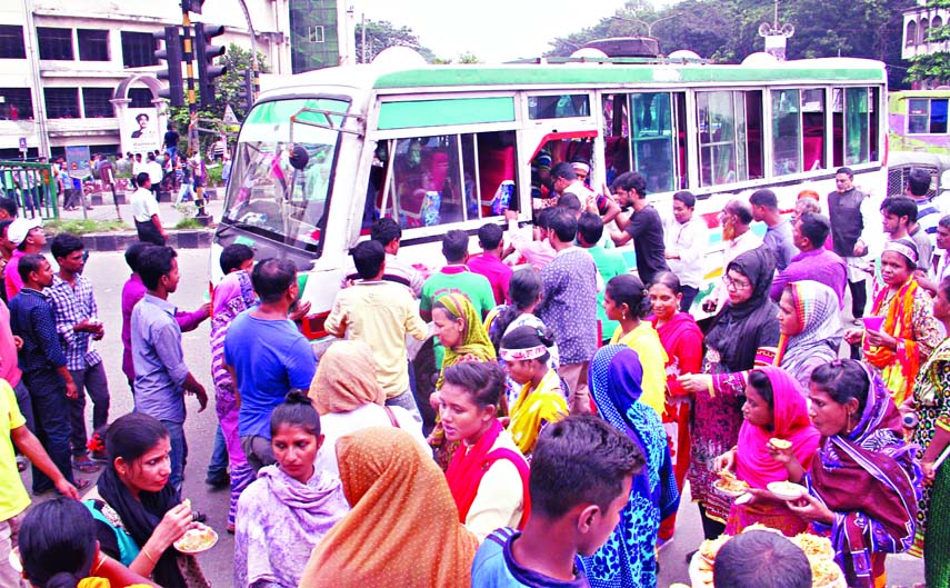 People crowding to aboard a bus as no bus available in the Capital due to Citizenâ€™s Conference at Suhrawardy Udyan on Saturday, causing sufferings to commuters and home-goers. This photo was taken from city's Shahbagh area.