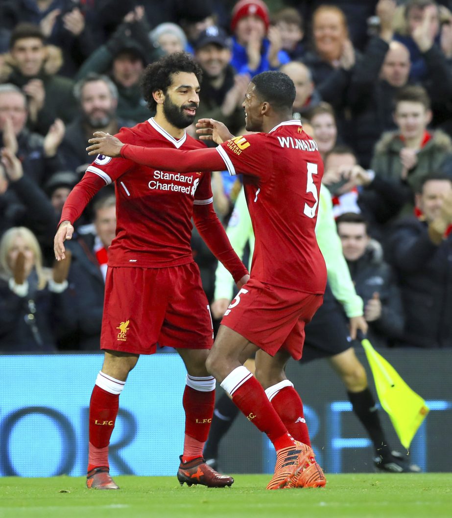 Liverpool's Mohamed Salah (left) celebrates scoring his side's first goal of the game with team mate Liverpool's Georginio Wijnaldum during the English Premier League soccer match Liverpool versus Southampton at Anfield, Liverpool, England on Saturday.