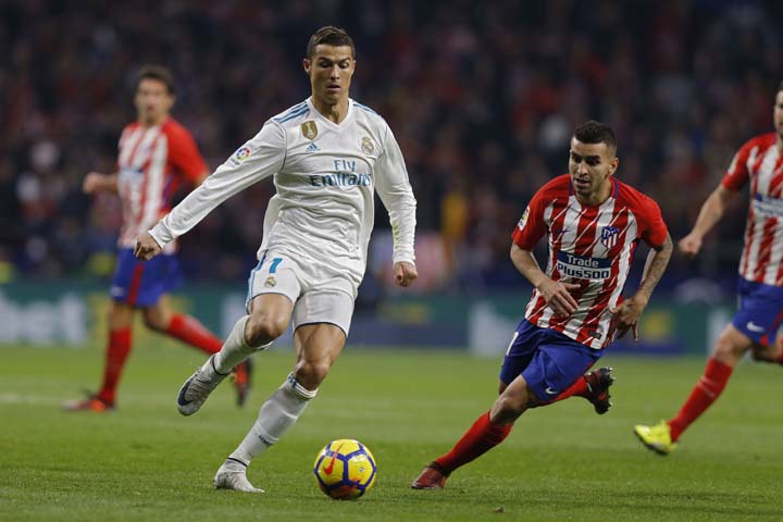 Real Madrid's Cristiano Ronaldo (left) battles for the ball with Atletico Madrid's Angel Correa during the Spanish La Liga soccer match between Real Madrid and Atletico at the Wanda Metropolitano stadium in Madrid on Saturday. The match ended in a 0-0 d