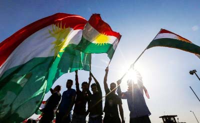 A file picture shows Iraqi Kurds waving flags during a demonstration on October 21, to protest against the escalating crisis with Baghdad