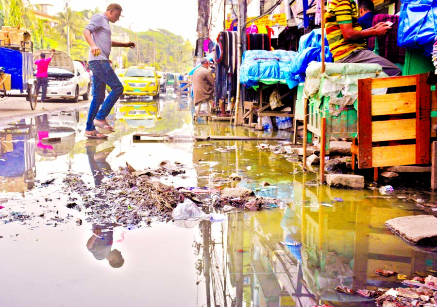 In absence of proper drainage system, the main thoroughfare of city's Fakirerpool area was inundated with dirty water causing sufferings for the people. This picture was taken on Monday.