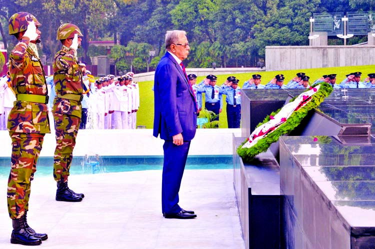President Abdul Hamid stands in solemn silence after placing floral wreaths at "Shikha Anirban' at Dhaka Cantonment on Tuesday on the occasion of Armed Forces Day. BSS photo"