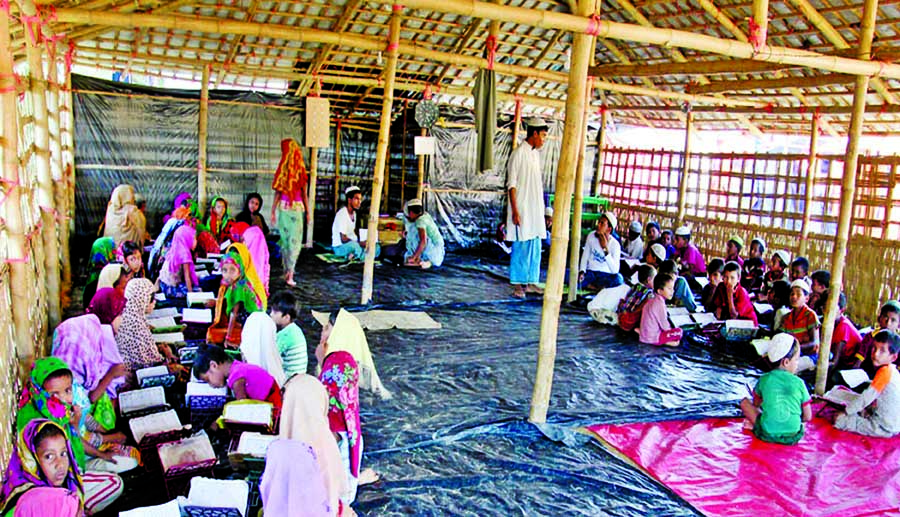 The displaced Rohingya children are learning the Quran at a mosque in the Balukhali temporary camp under Ukhiya upazila in Cox's Bazar district.