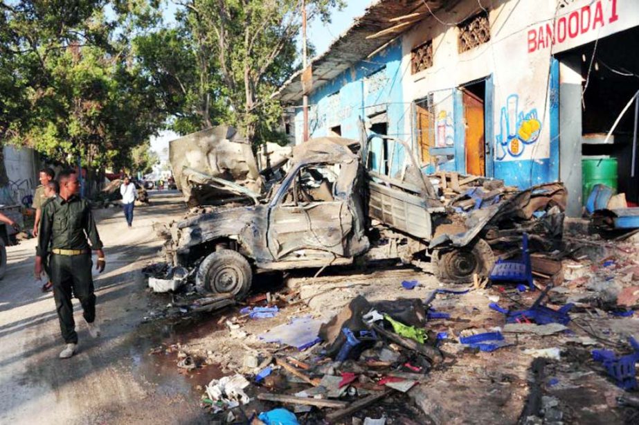 Residents walk past the scene of an October bomb blast in Somalia's capital Mogadishu.