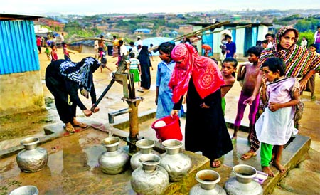 Local government authorities and different local and foreign NGOs have installed tube-wells to ensure supply of sufficient drinking water to the displaced Rohingya people. In the photo Rohingya women are seen collecting water with jars from a tube well as