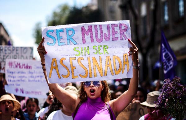 A woman in Mexico, one of the most dangerous countries for women according to the UN, protests with a sign reading: 'To be a woman without being murdered'.