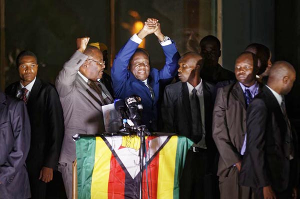 Zimbabwe's President in waiting Emmerson Mnangagwa, greets supporters gathered outside the Zanu-PF party headquarters in Harare, Zimbabwe on Wednesday.